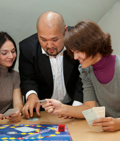 Zur trio of students with boardgame